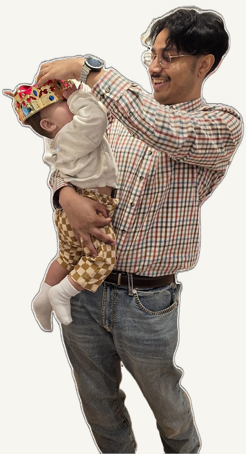 Akash Hashmi, founder of Cited, lifting his young child who is wearing a toy crown