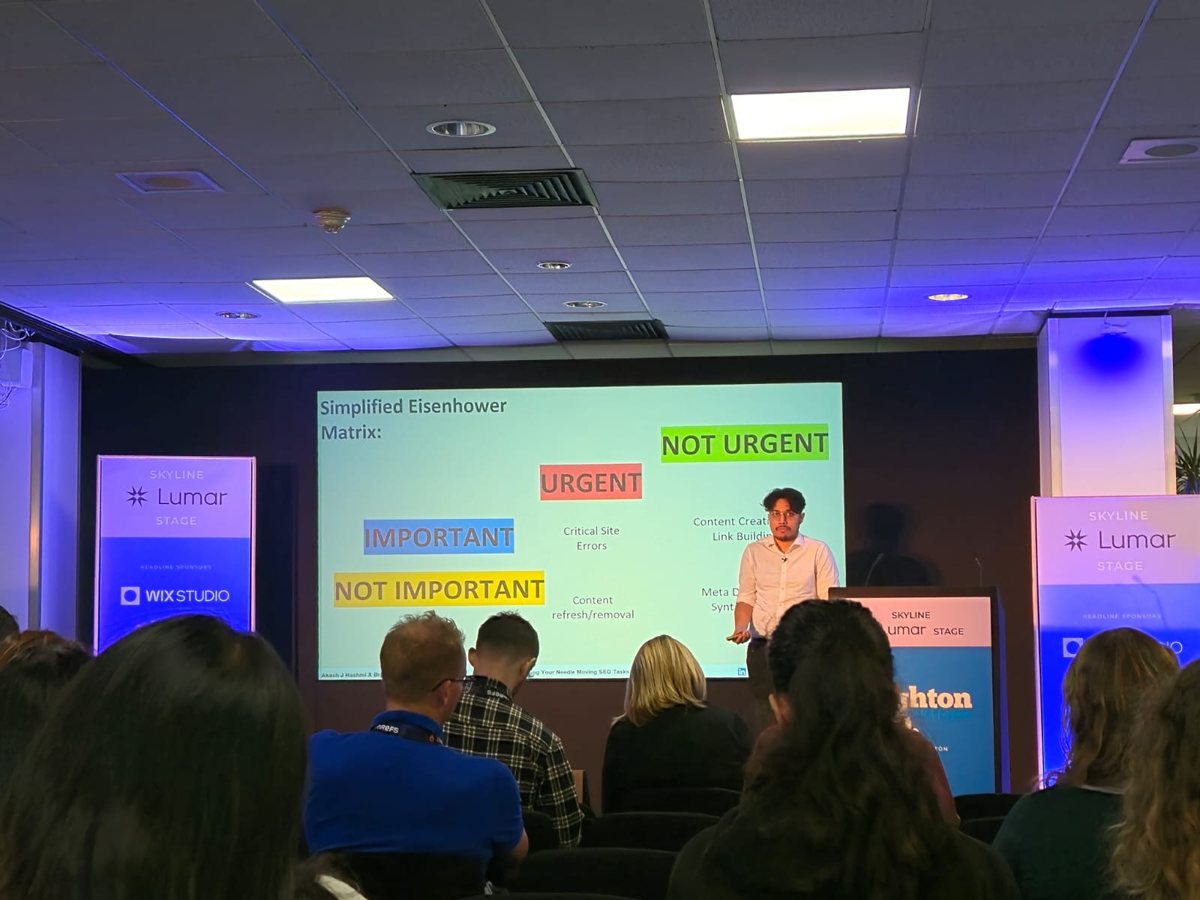 Akash Hashmi presenting a prioritisation matrix to a seated audience at a Brighton SEO session
